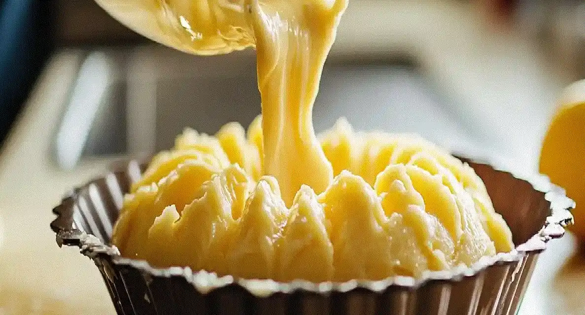 Batter being poured into a fluted Bundt pan